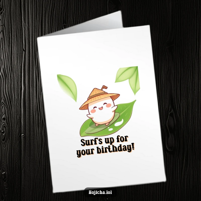 Funny Free Printable Giggling Mochi wearing a straw hat, surfing a green tea leaf, ready for a birthday.