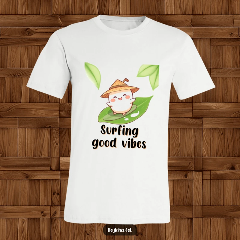 A giggling mochi wearing a straw hat is pretending to surf on a large green tea leaf t-shirt.